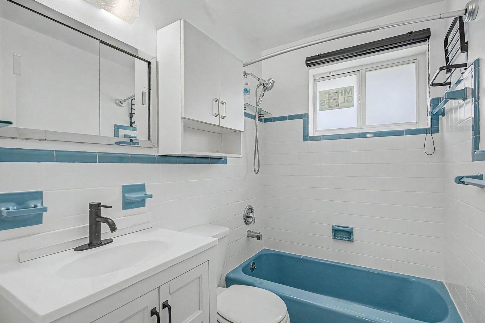 Bathroom with vanity and tub